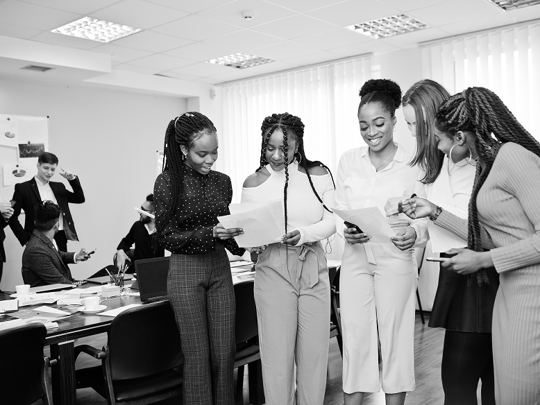 People standing together looking at a paper