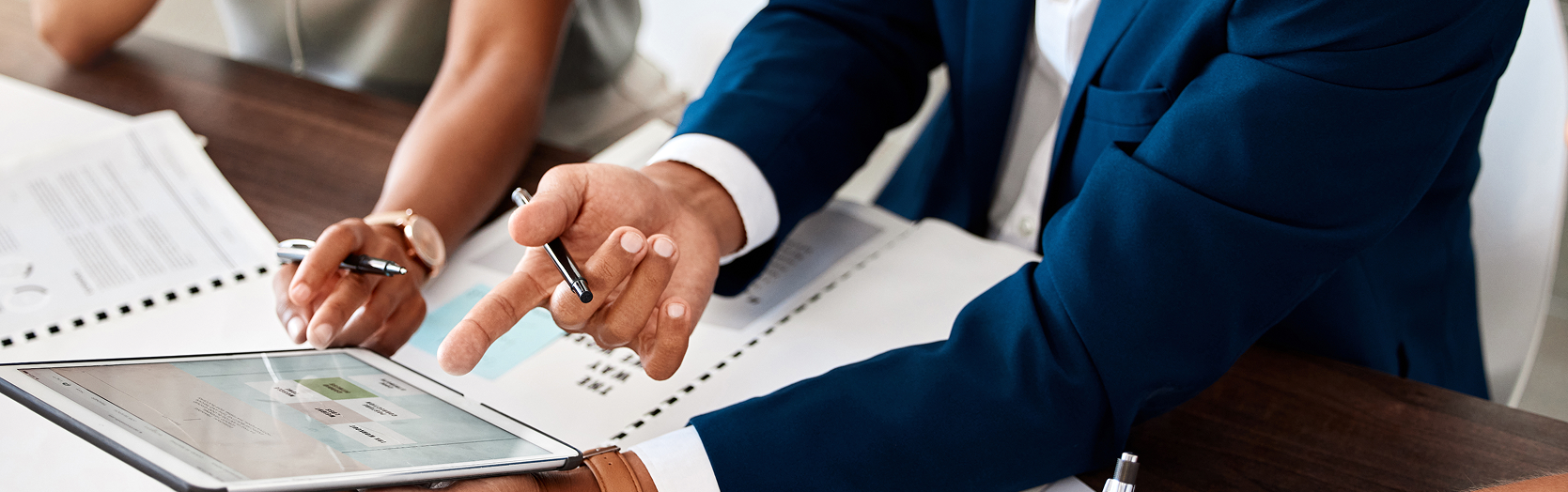 People pointing at iPad
